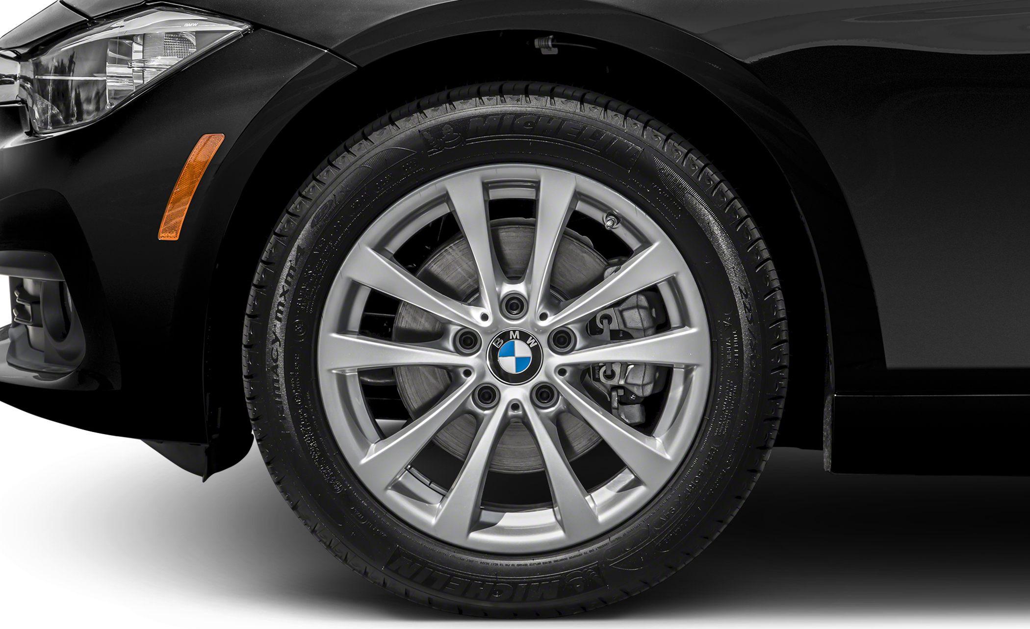 Close-up of alloy wheel and front fender with brake disc and Michelin tire