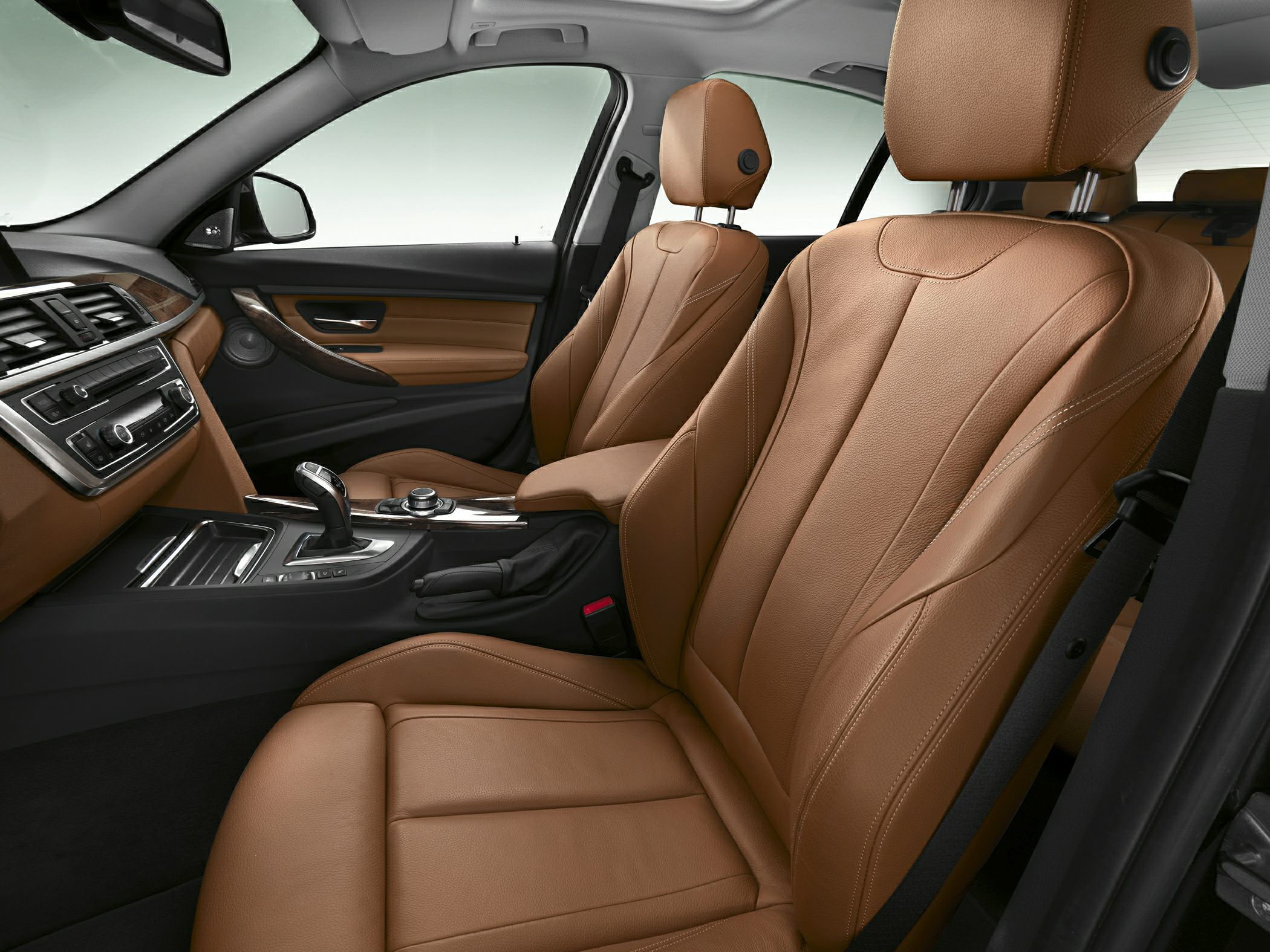Luxury brown leather seats with modern car interior layout.