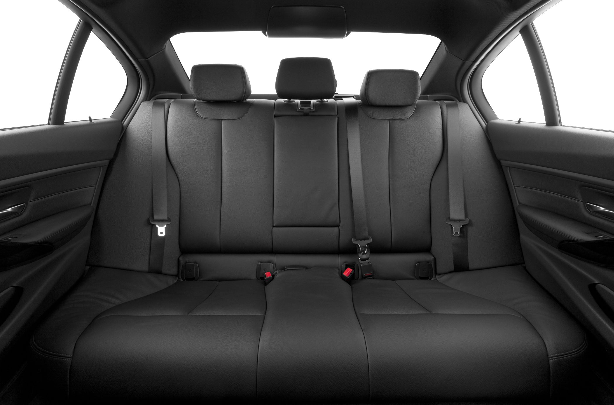 Black leather rear seats with seat belts in a sedan interior