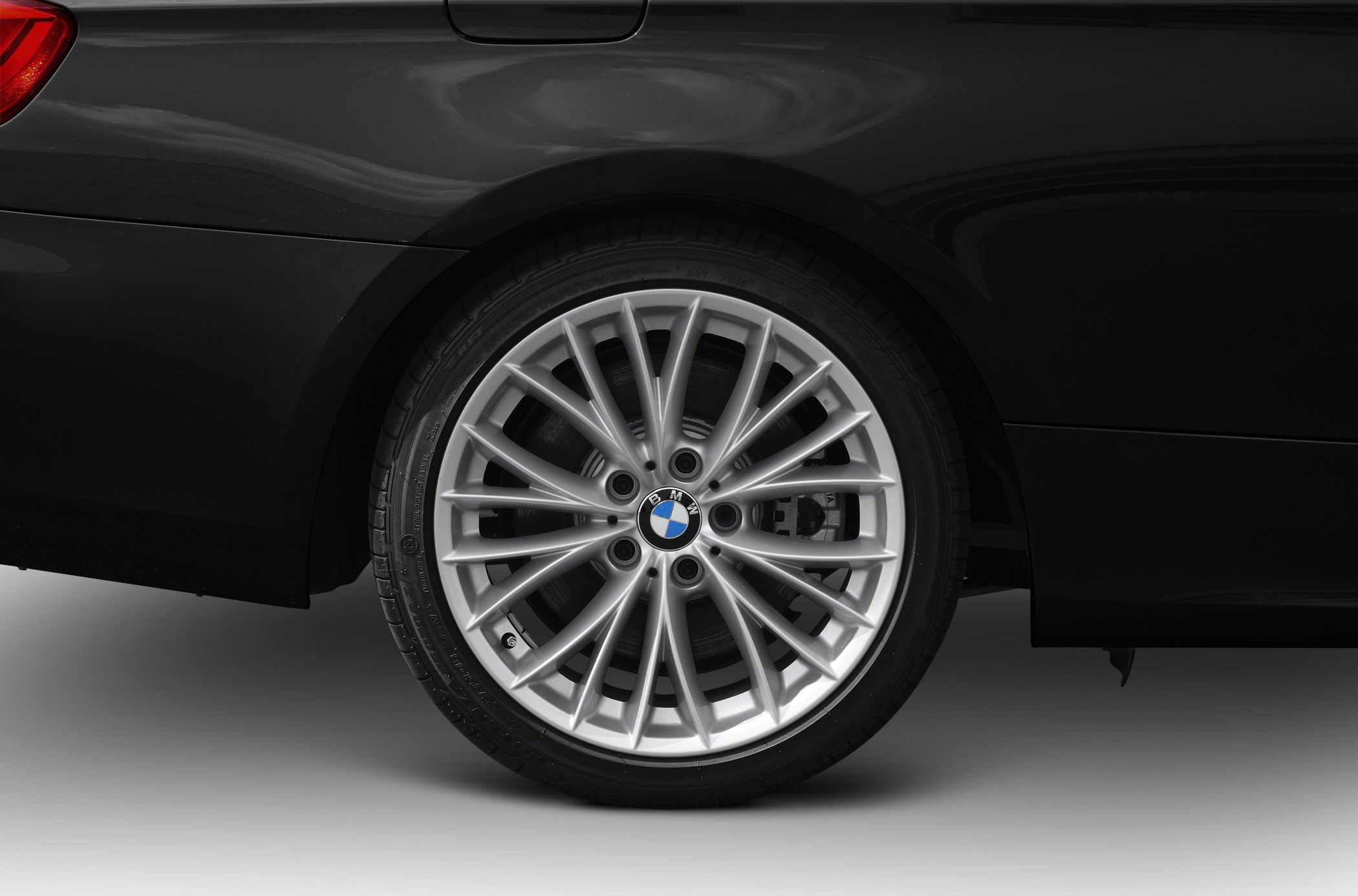 Multi-spoke silver alloy wheel with tire and brake disc