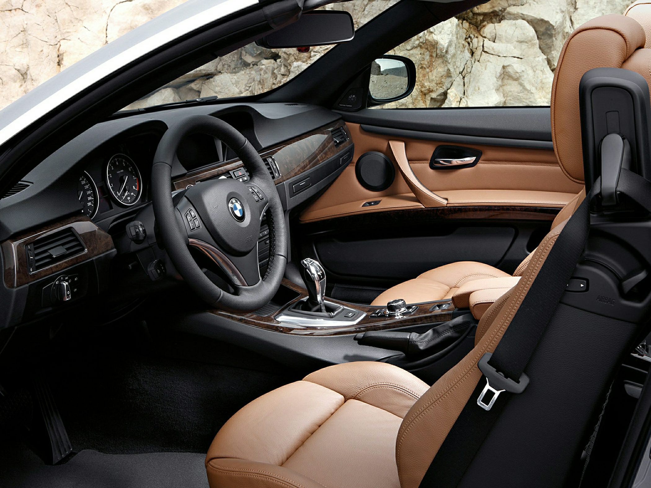 Tan leather seats and modern dashboard in a convertible interior