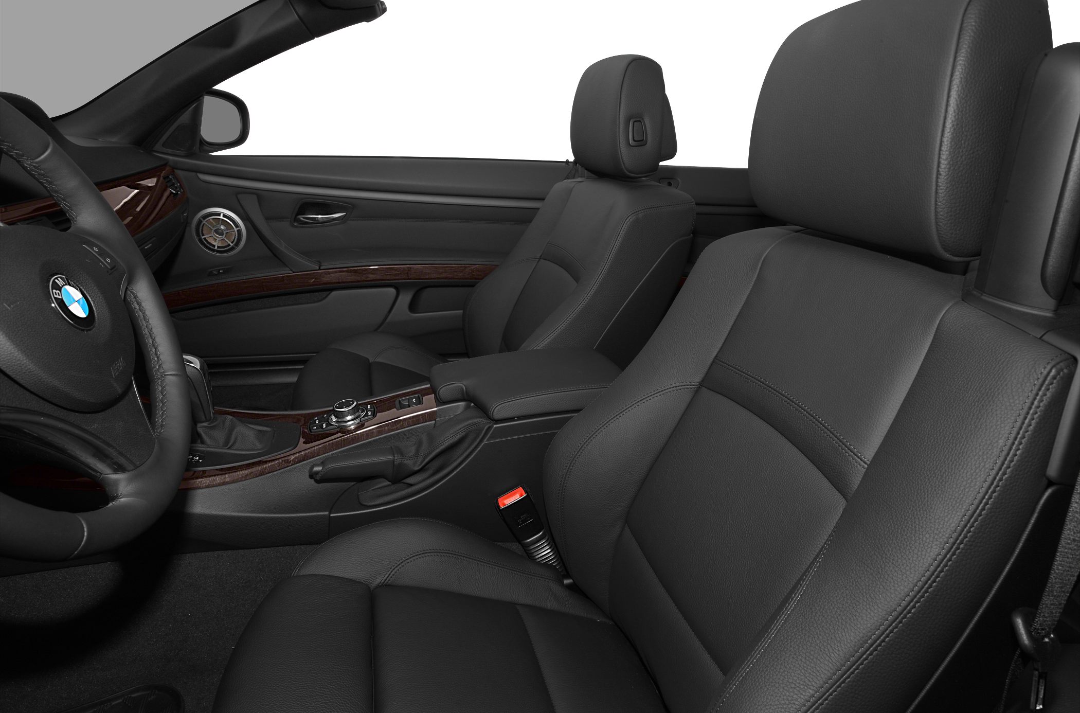 Black leather seats and wood-trimmed dashboard interior close-up