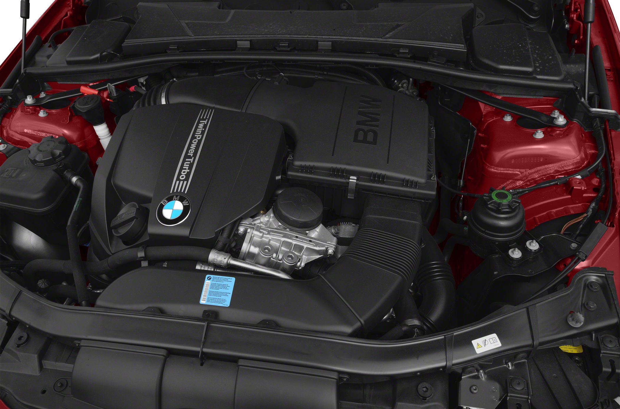 TwinPower Turbo engine bay with visible BMW engine cover and red chassis