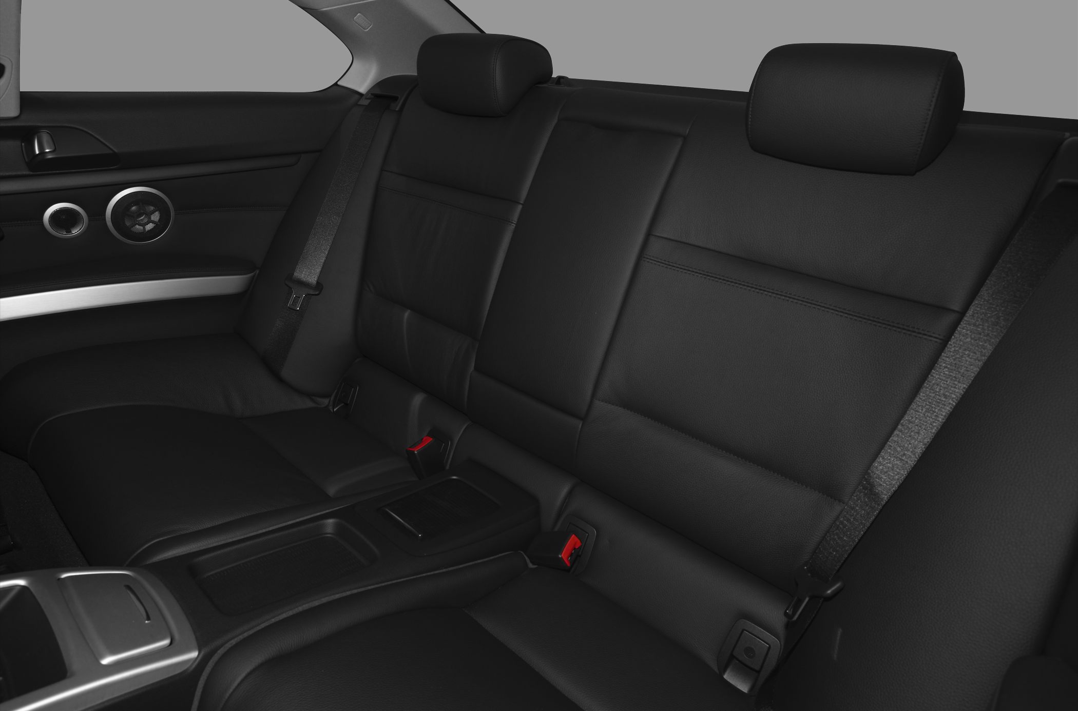 Rear black leather car seating with armrest and seatbelts