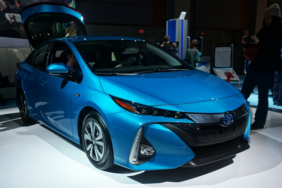 Front view of a blue hybrid car with LED headlights and aerodynamic styling