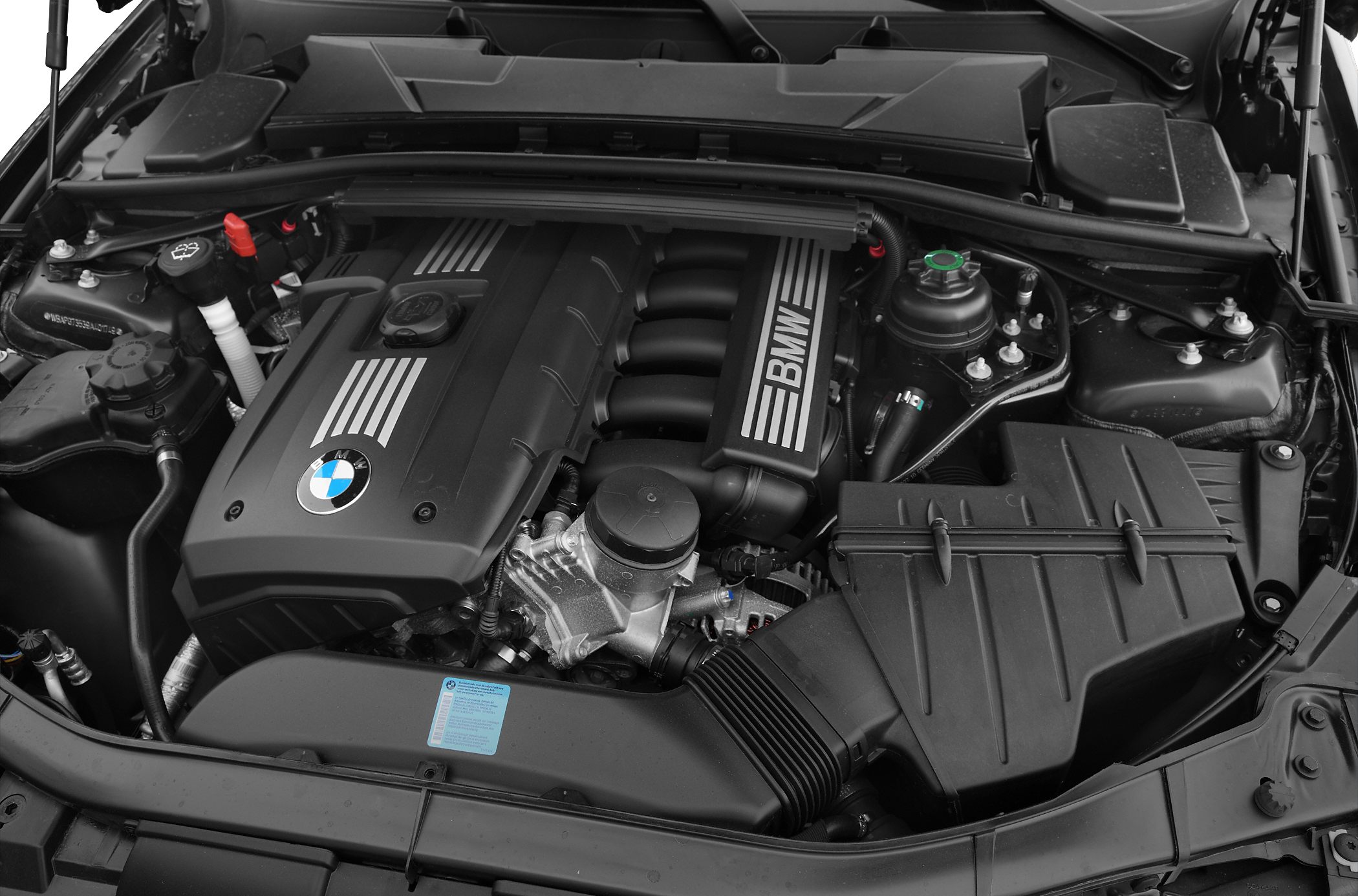 BMW inline-6 engine with engine cover and components under the hood