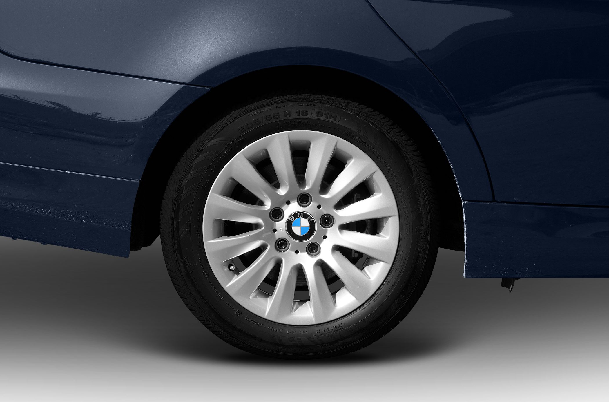 Alloy wheel and rear quarter panel close-up with visible tire and BMW logo