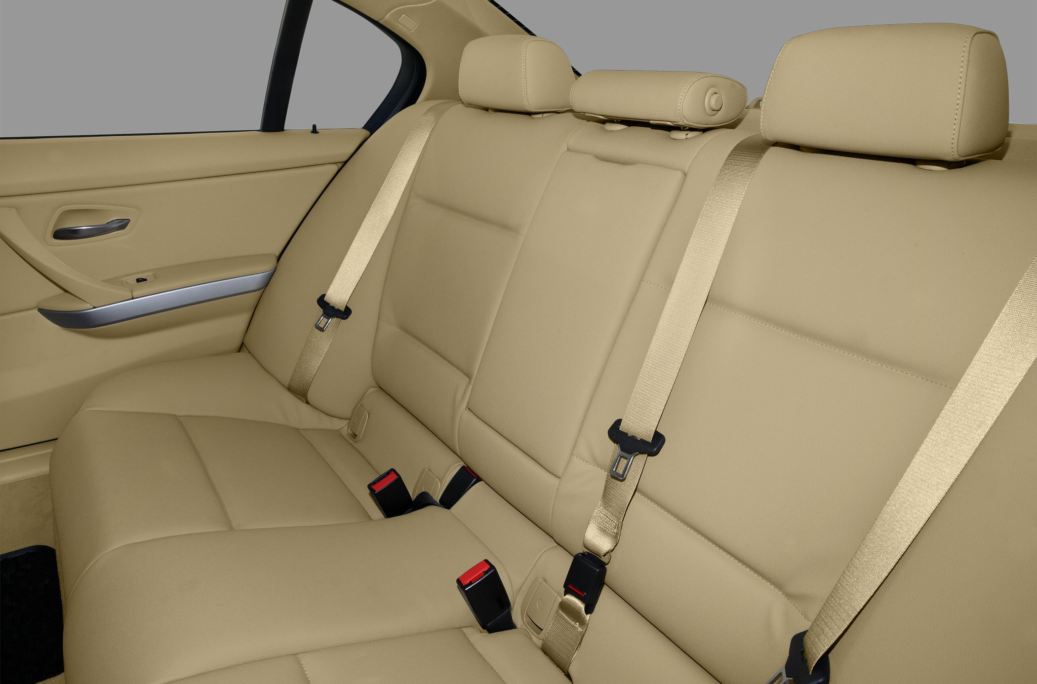 Beige leather rear seats with headrests and seat belts