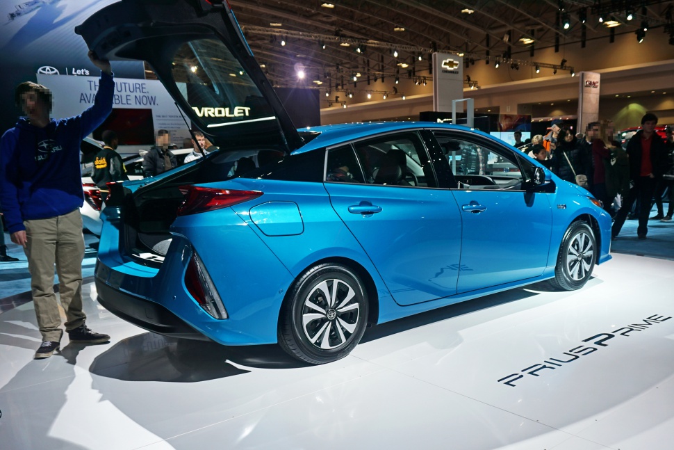 Blue hatchback with open rear hatch and angular taillights