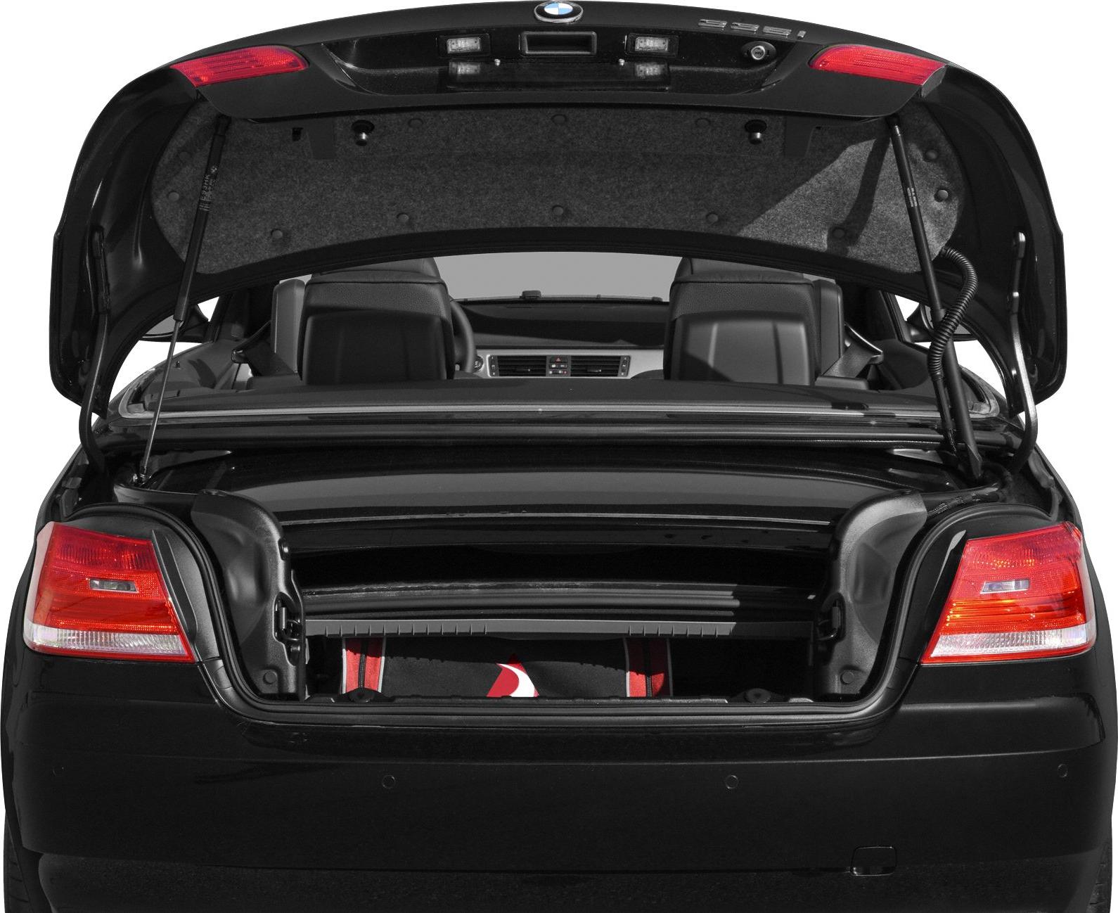 Convertible roof mechanism and open trunk with rear seats visible