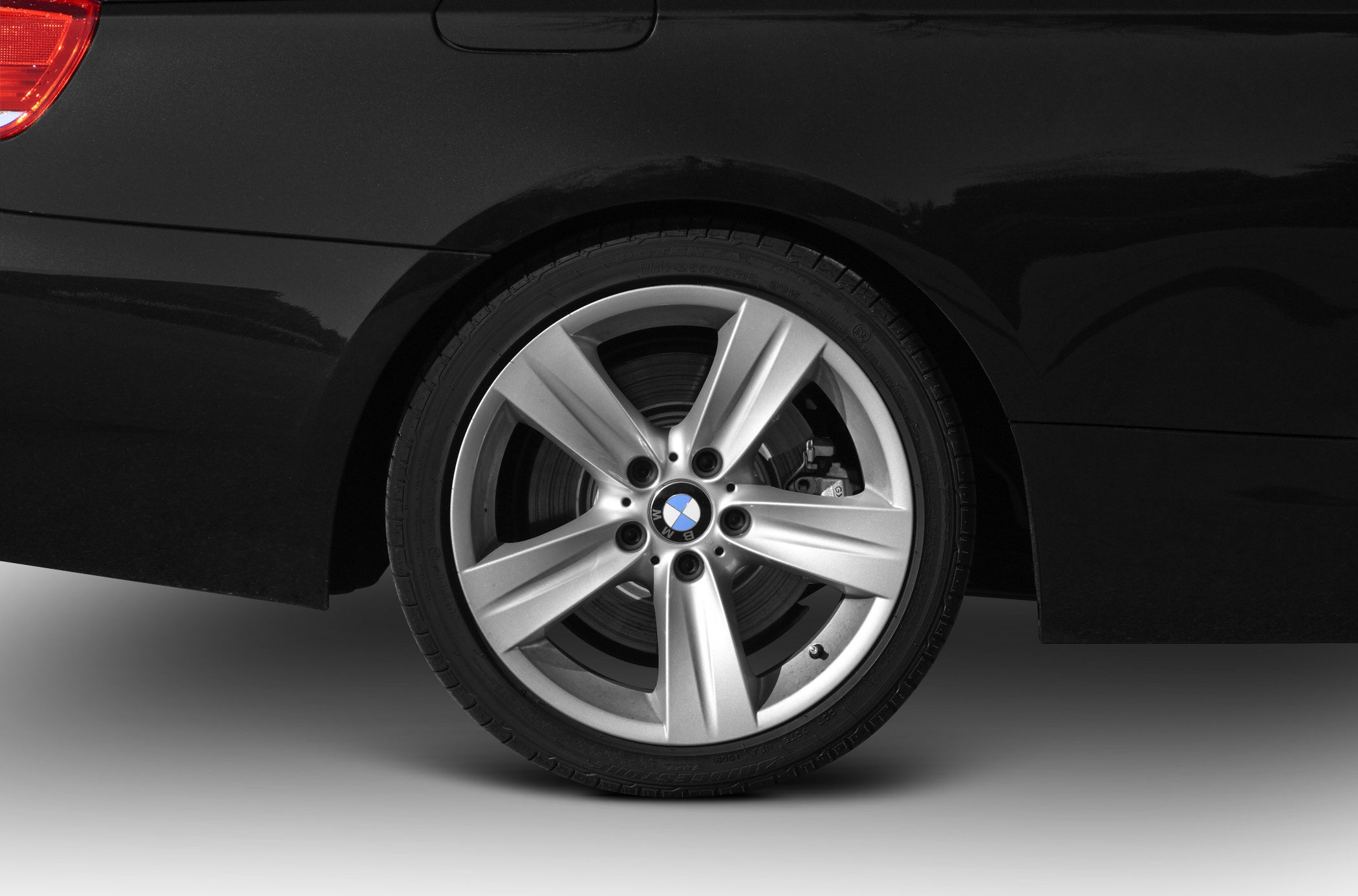 Close-up of silver alloy wheel and brake disc with caliper