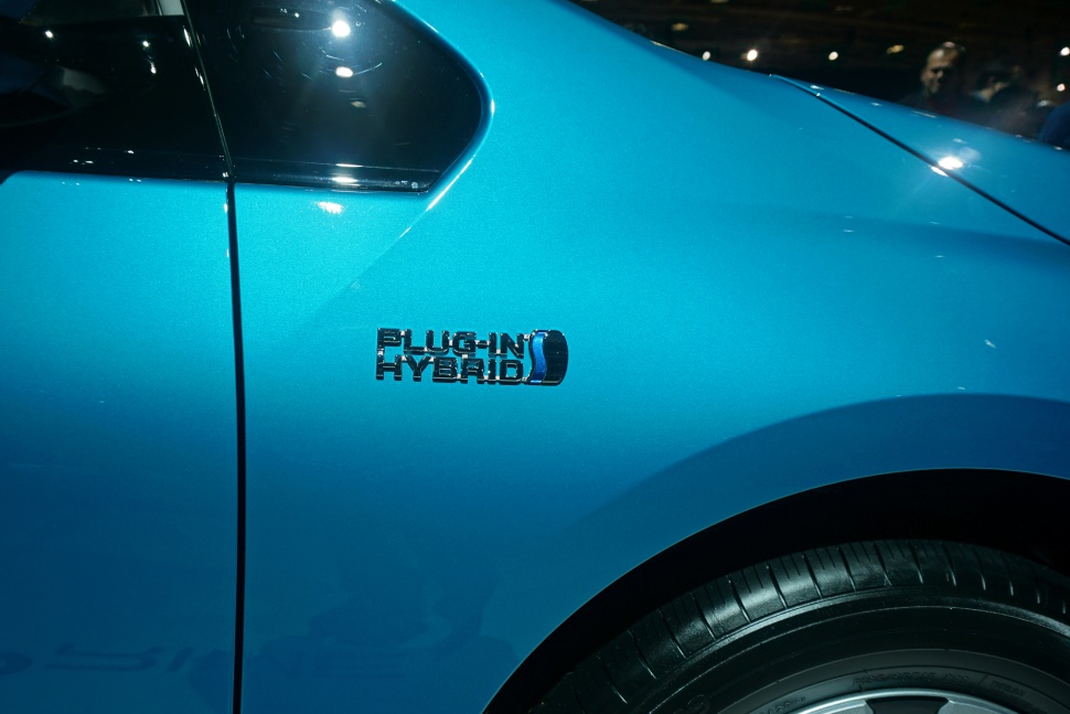 Close-up of a blue car fender with a plug-in hybrid badge.