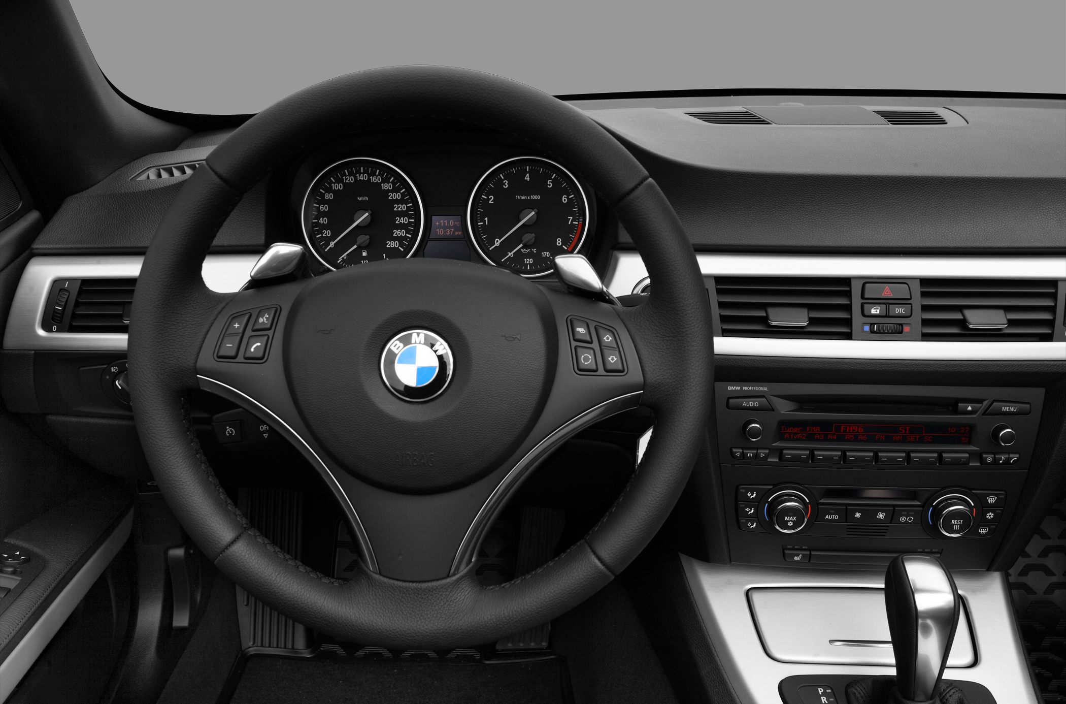 Steering wheel with multifunction controls and dashboard with instrument cluster and climate controls