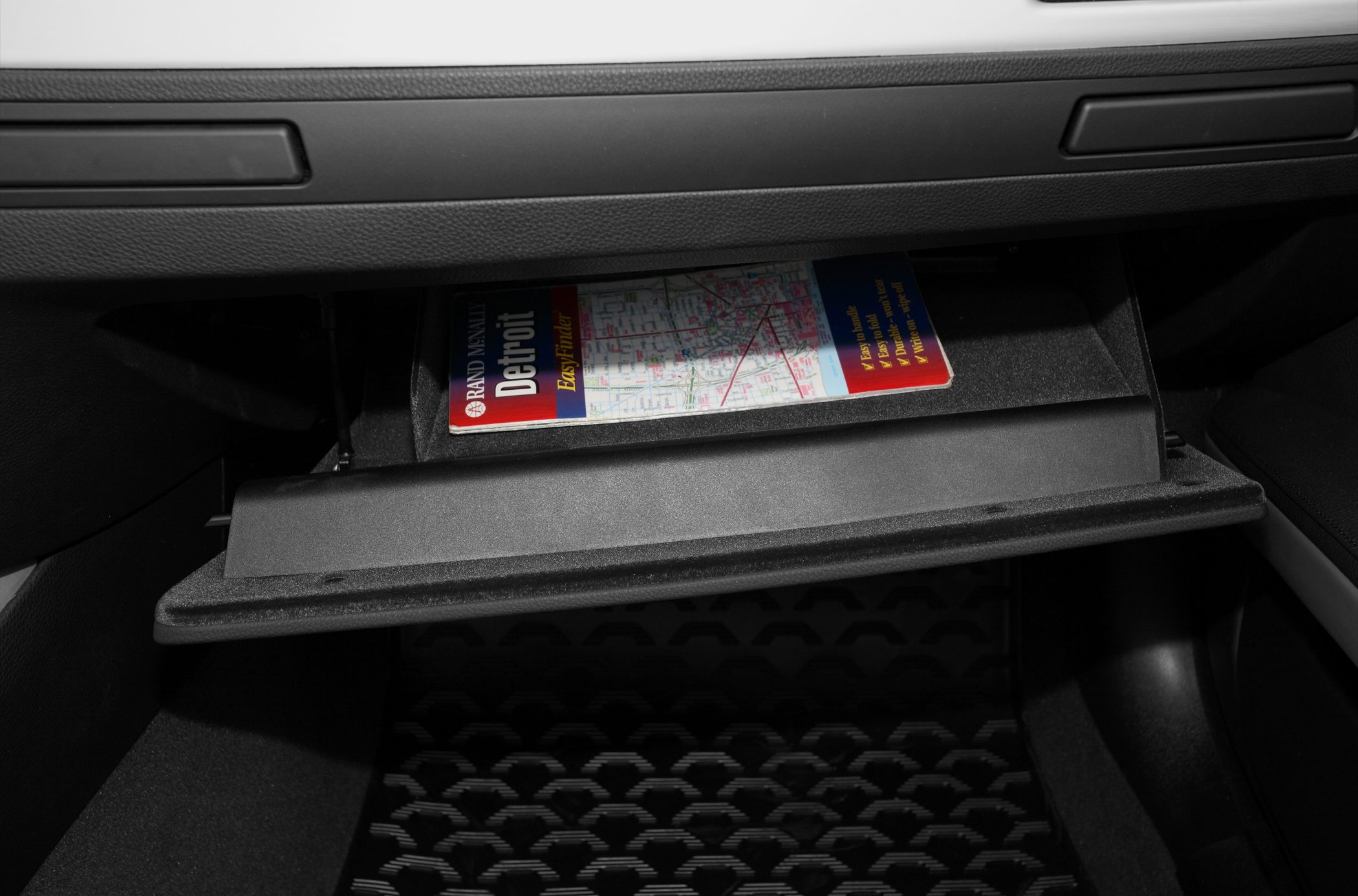 Open glove compartment with storage shelf and map inside