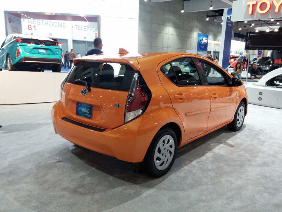 Rear view of a 2017 hybrid hatchback with distinct taillights and orange paint.