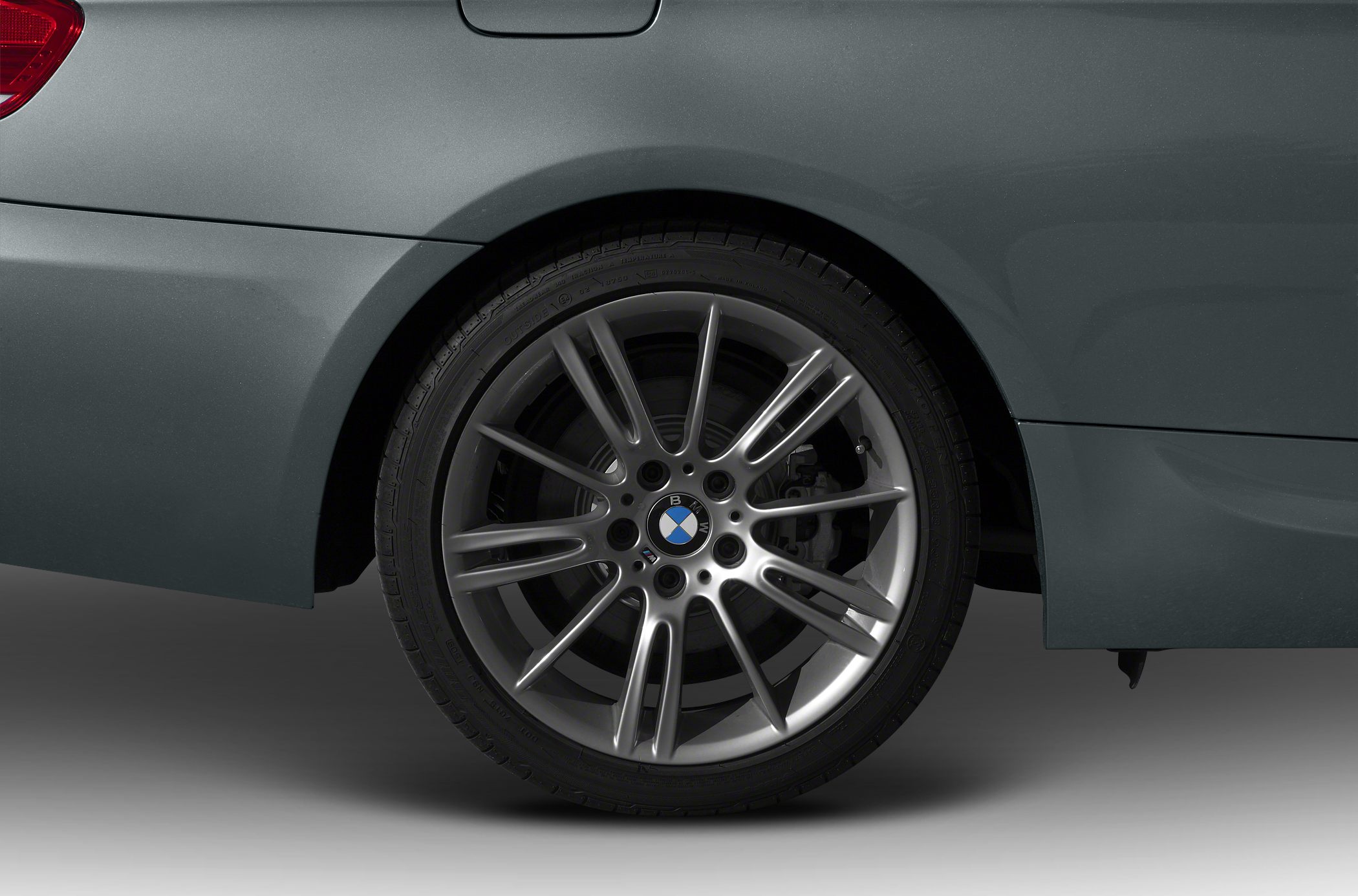 Multi-spoke alloy rear wheel and rear quarter panel.