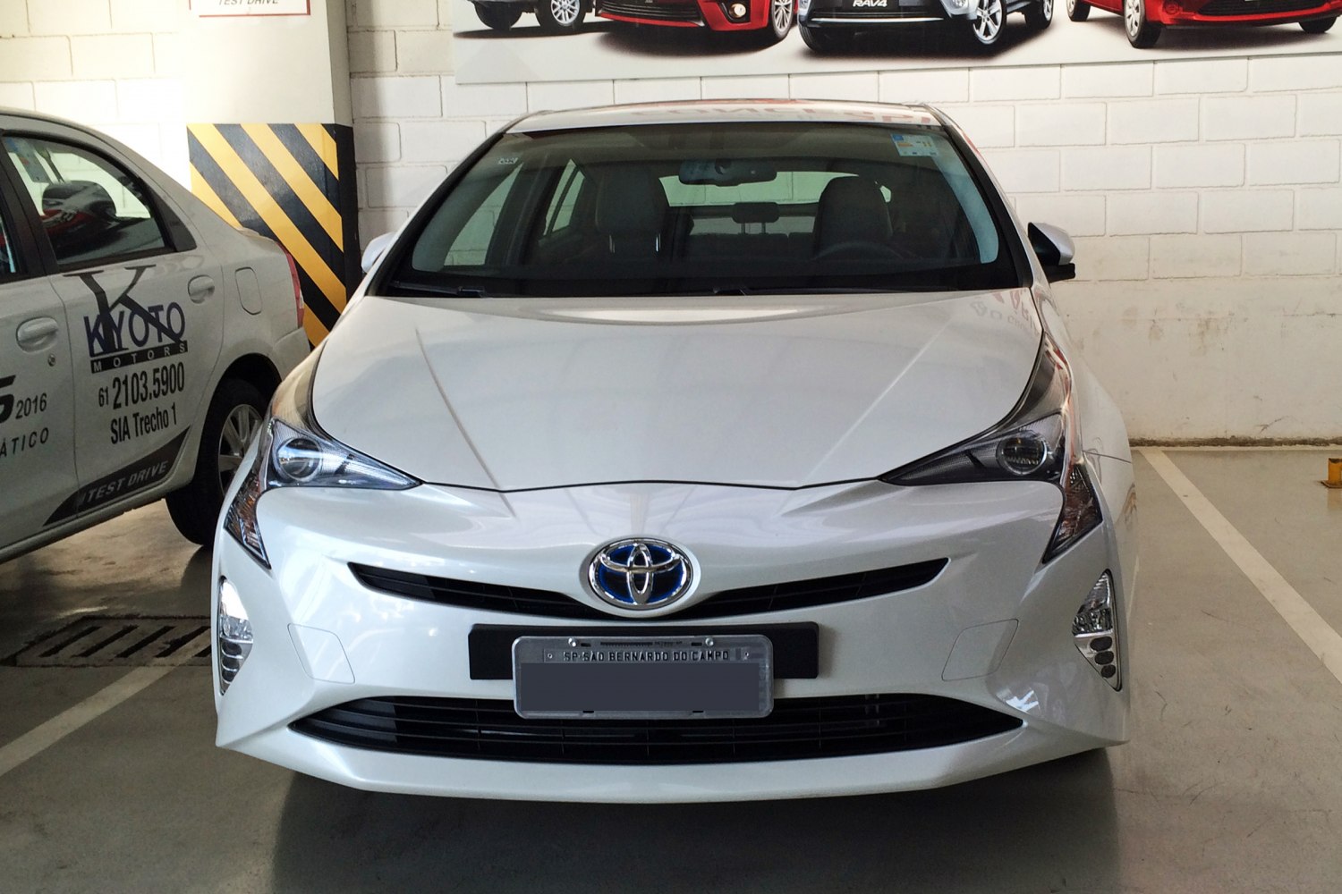 Front view of hybrid car with sleek headlights and aerodynamic grille