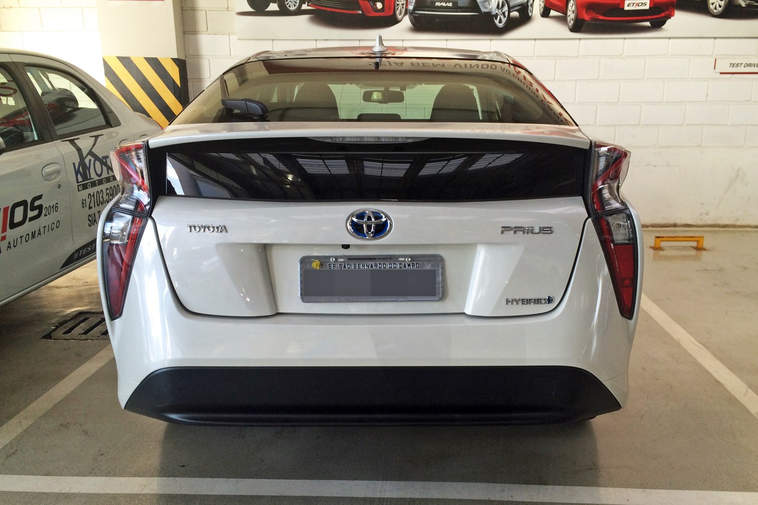 Rear view with distinctive vertical tail lights and hybrid badge