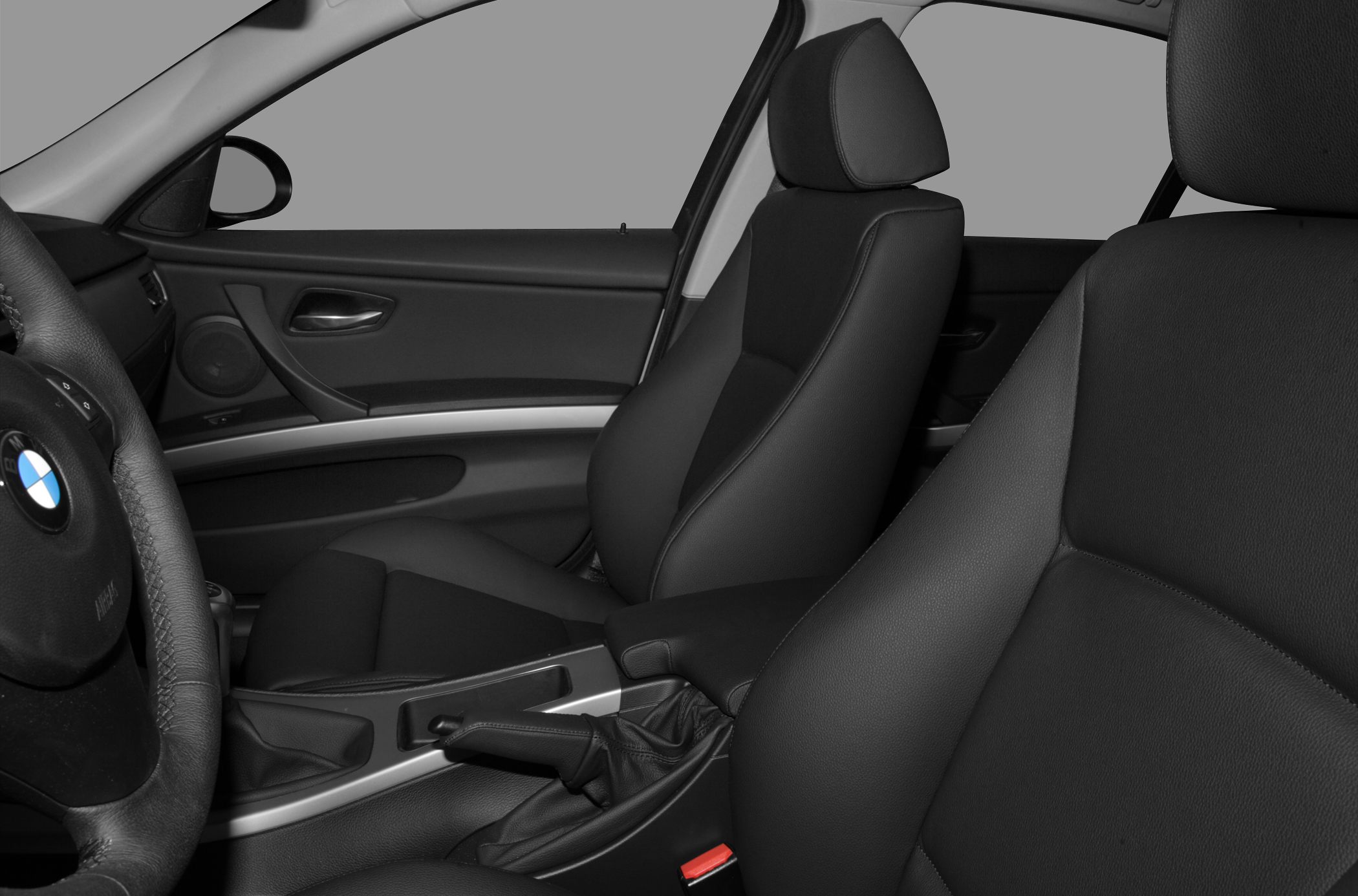 Black leather front seats and dashboard with steering wheel and manual handbrake