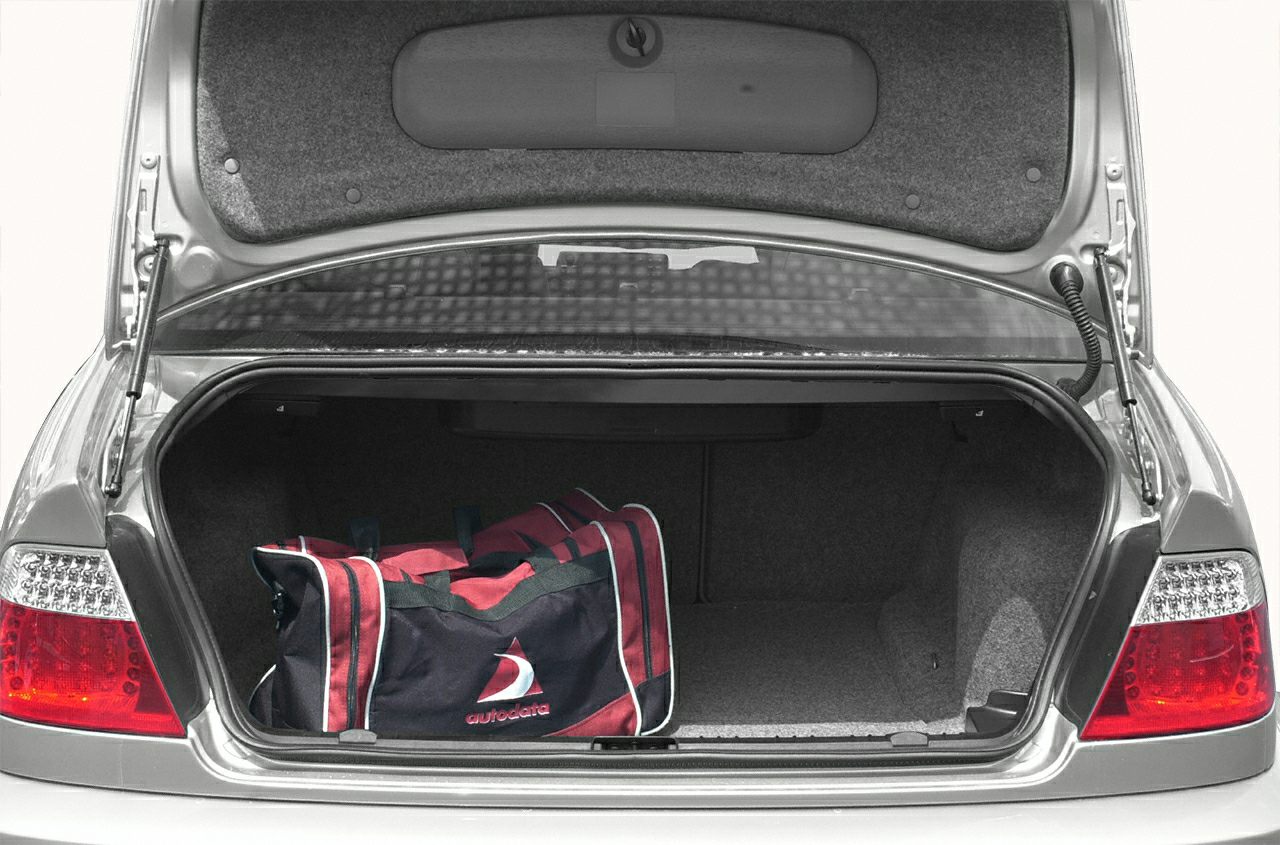 Open trunk of a coupe with a sports bag inside