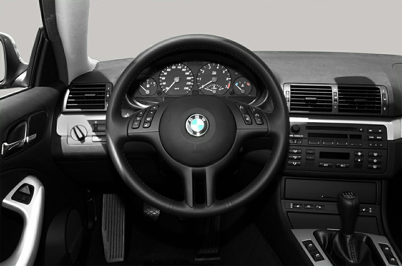 Dashboard, steering wheel, and center console of a 2004 vehicle interior