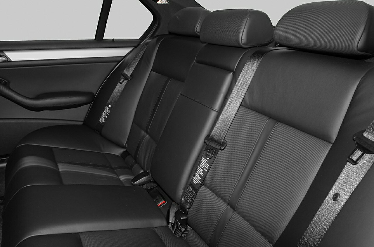 Rear seat with leather upholstery, headrests, and seat belts