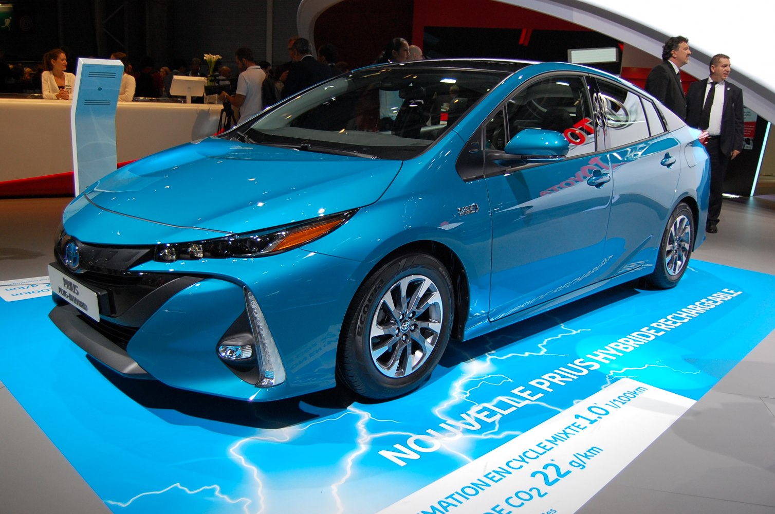 Blue hybrid car with distinctive headlights and sleek aerodynamic profile