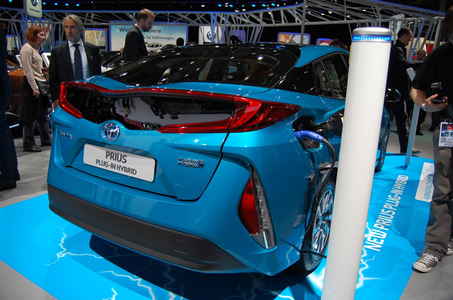 Rear view of a blue plug-in hybrid charging