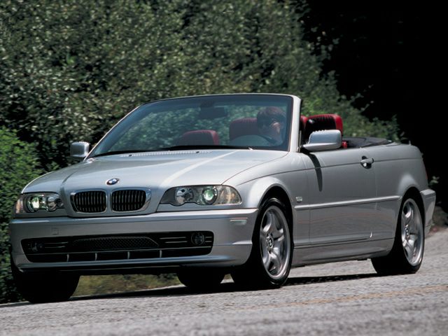 Front angled view of silver convertible with open roof and sporty styling