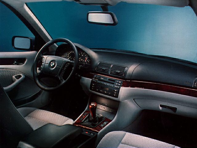 Classic sedan interior with dashboard, steering wheel, and center console.