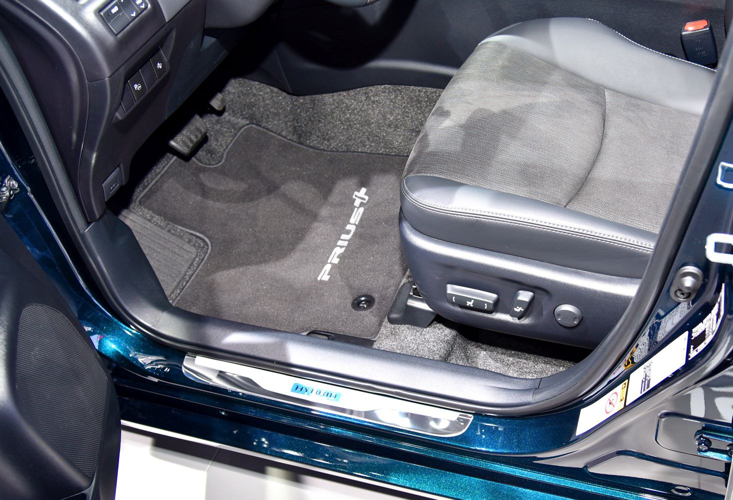 Driver seat with power adjustments and branded floor mat