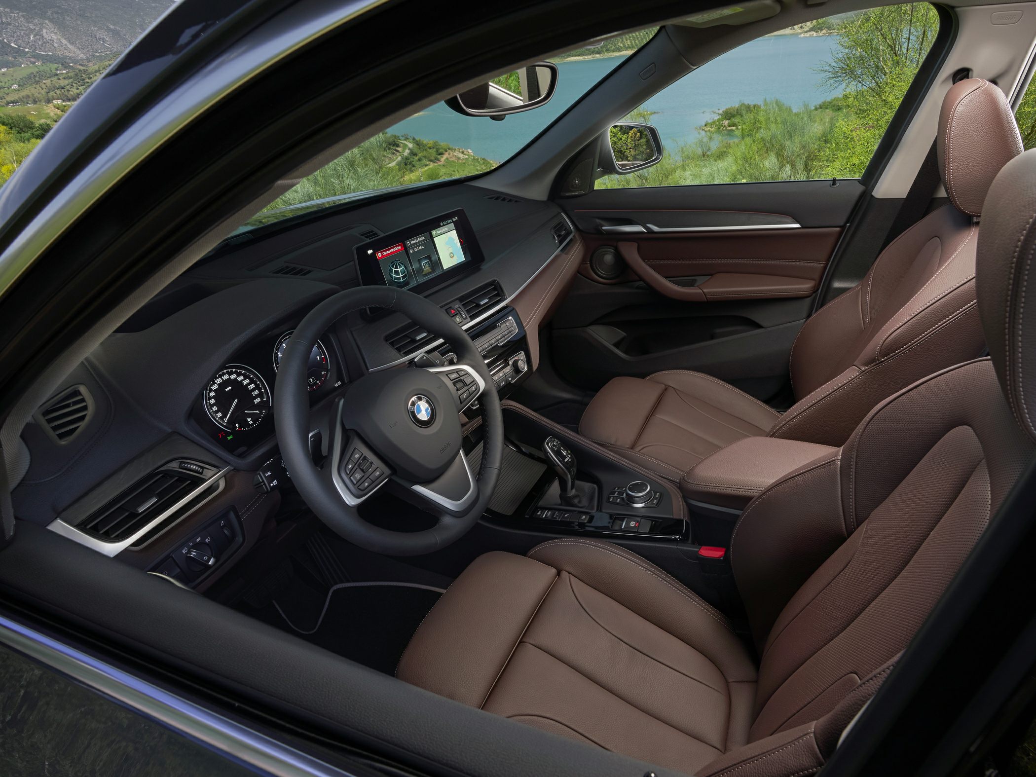 Luxury brown leather seats and advanced infotainment system inside a compact SUV