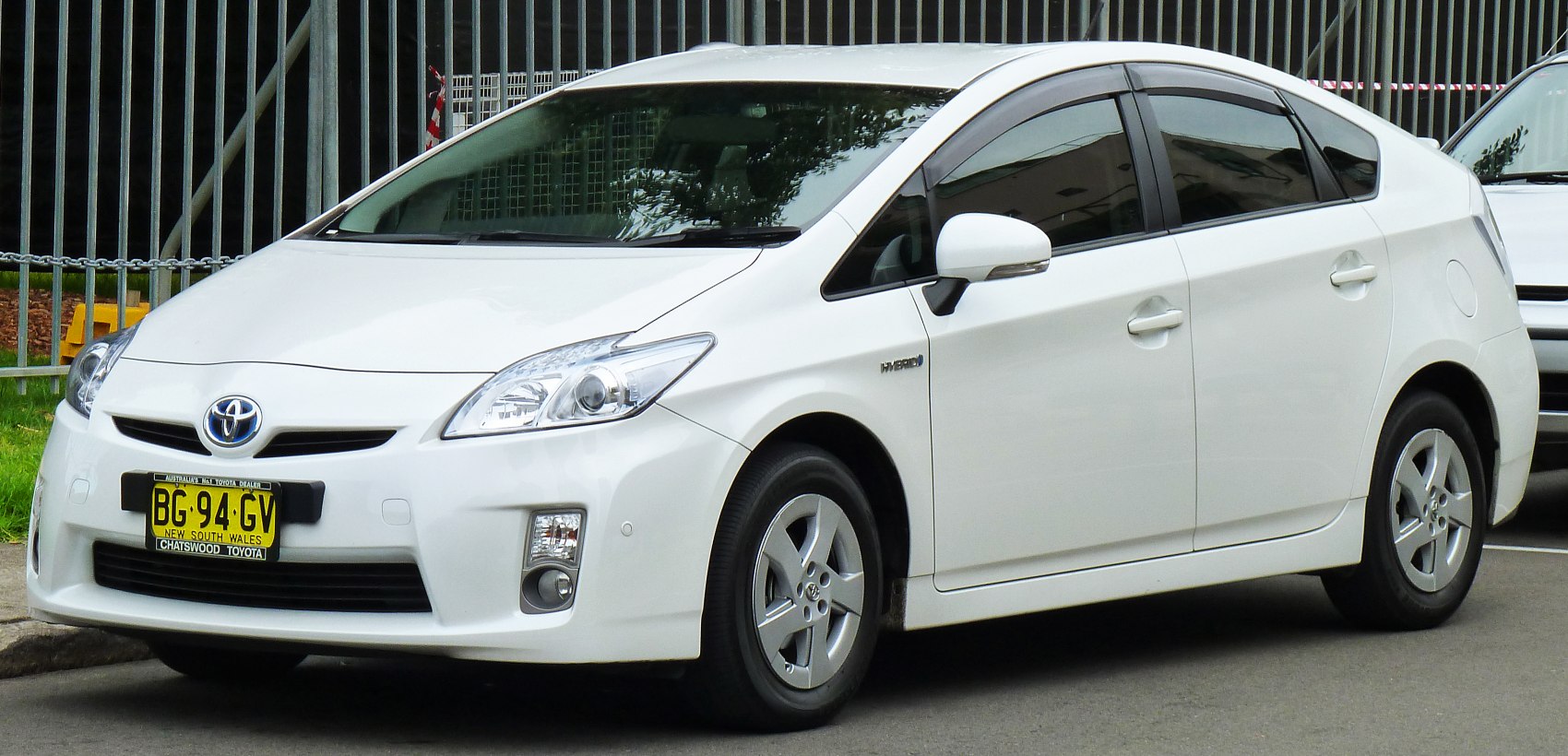 White hybrid hatchback with aerodynamic body and alloy wheels