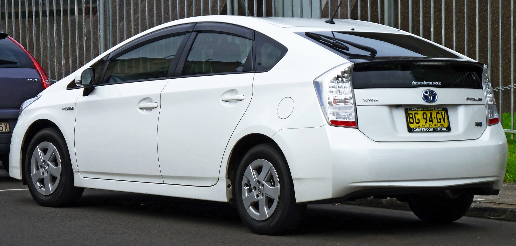 White hybrid hatchback rear and side view