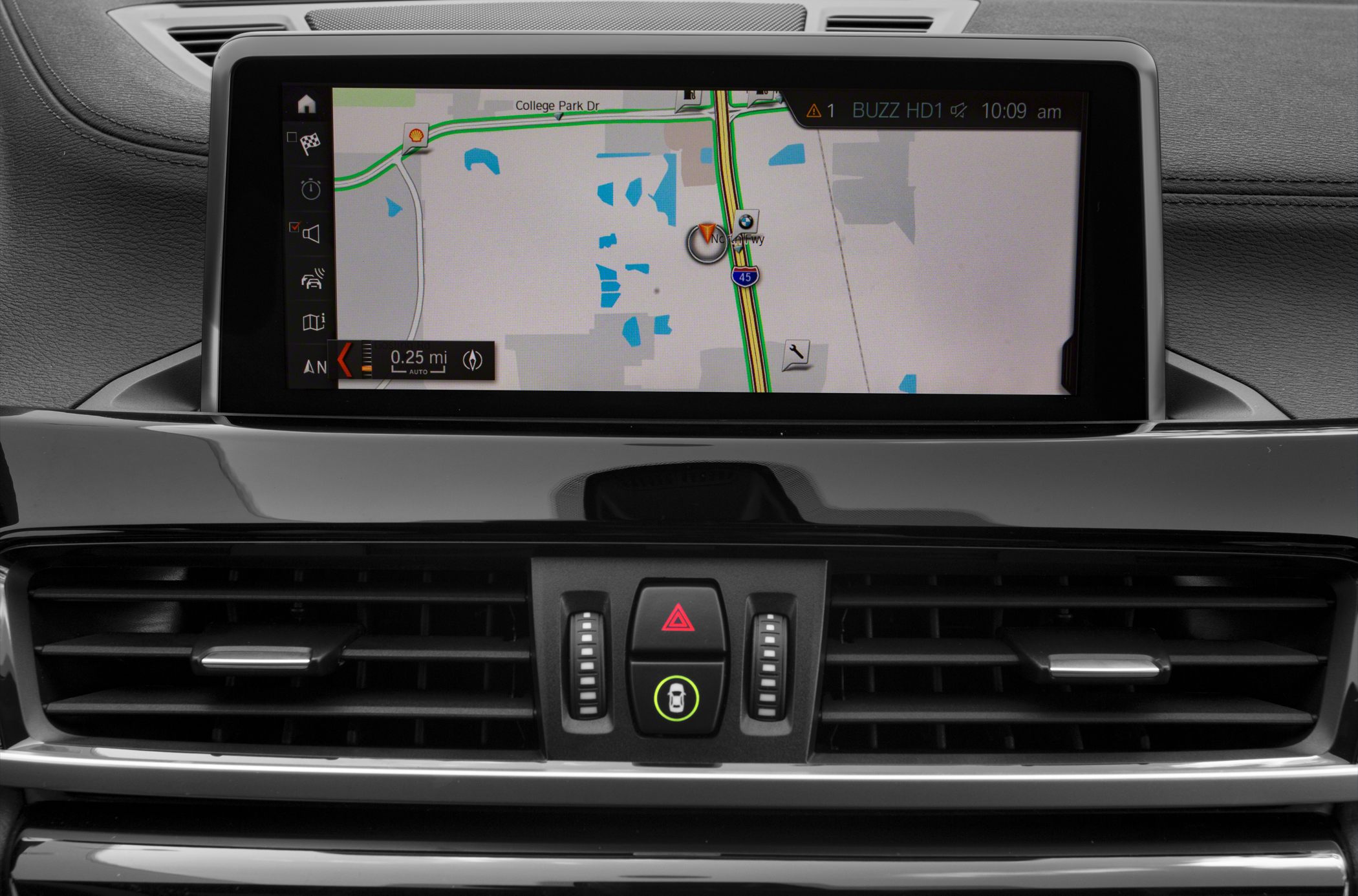 Car dashboard center console with navigation screen and air vents