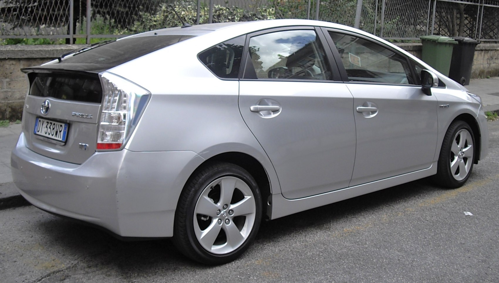 Silver hybrid hatchback showing rear side profile and alloy wheels
