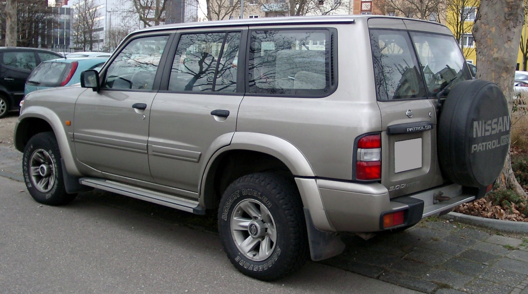 SUV rear side with spare wheel cover and off-road tires