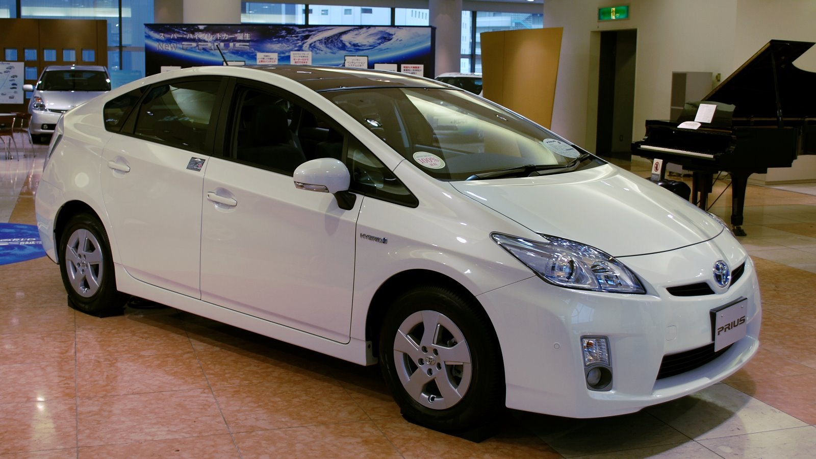 White hybrid sedan with sleek aerodynamic lines and alloy wheels
