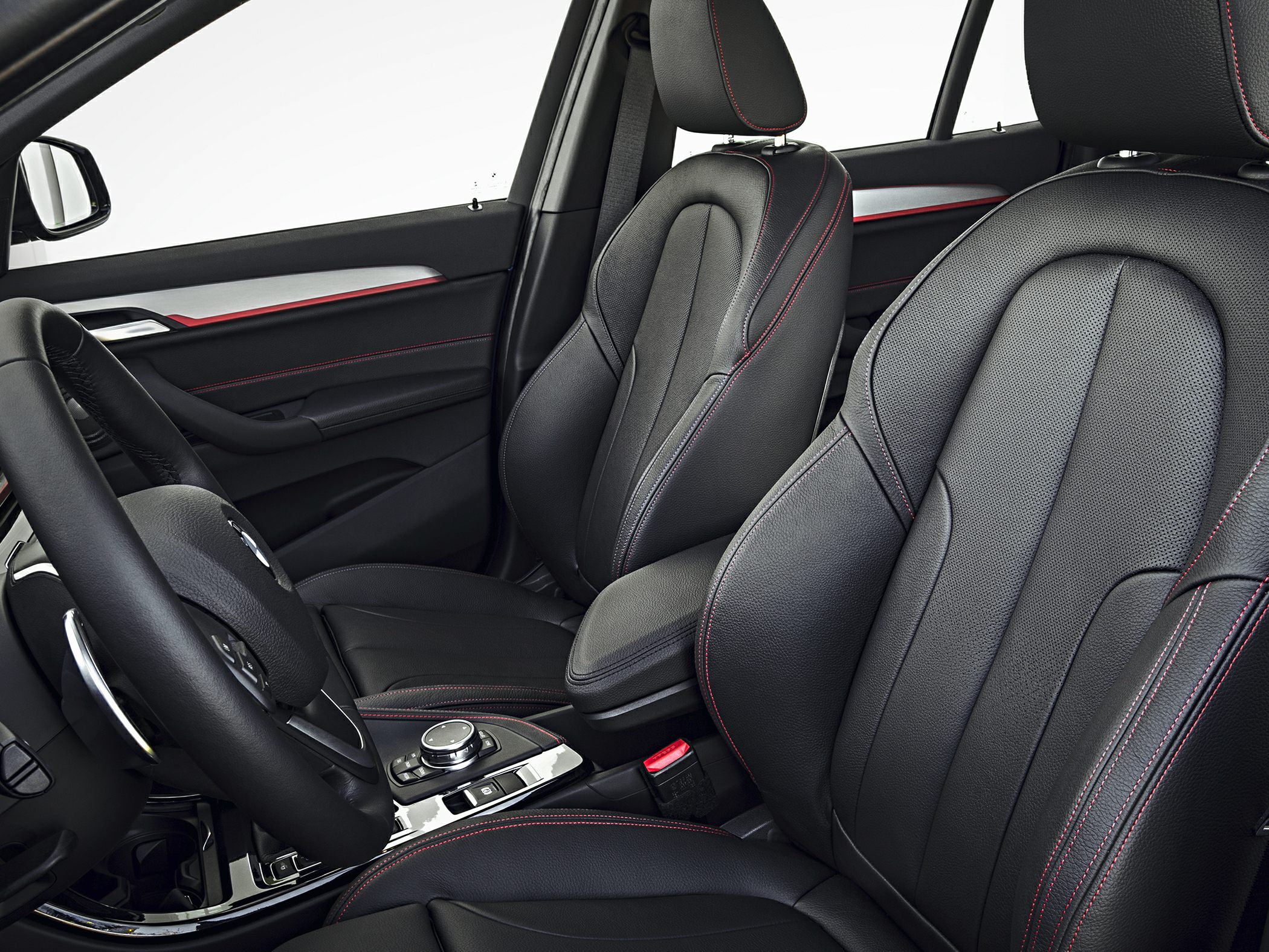 Black leather front seats with red stitching and steering wheel