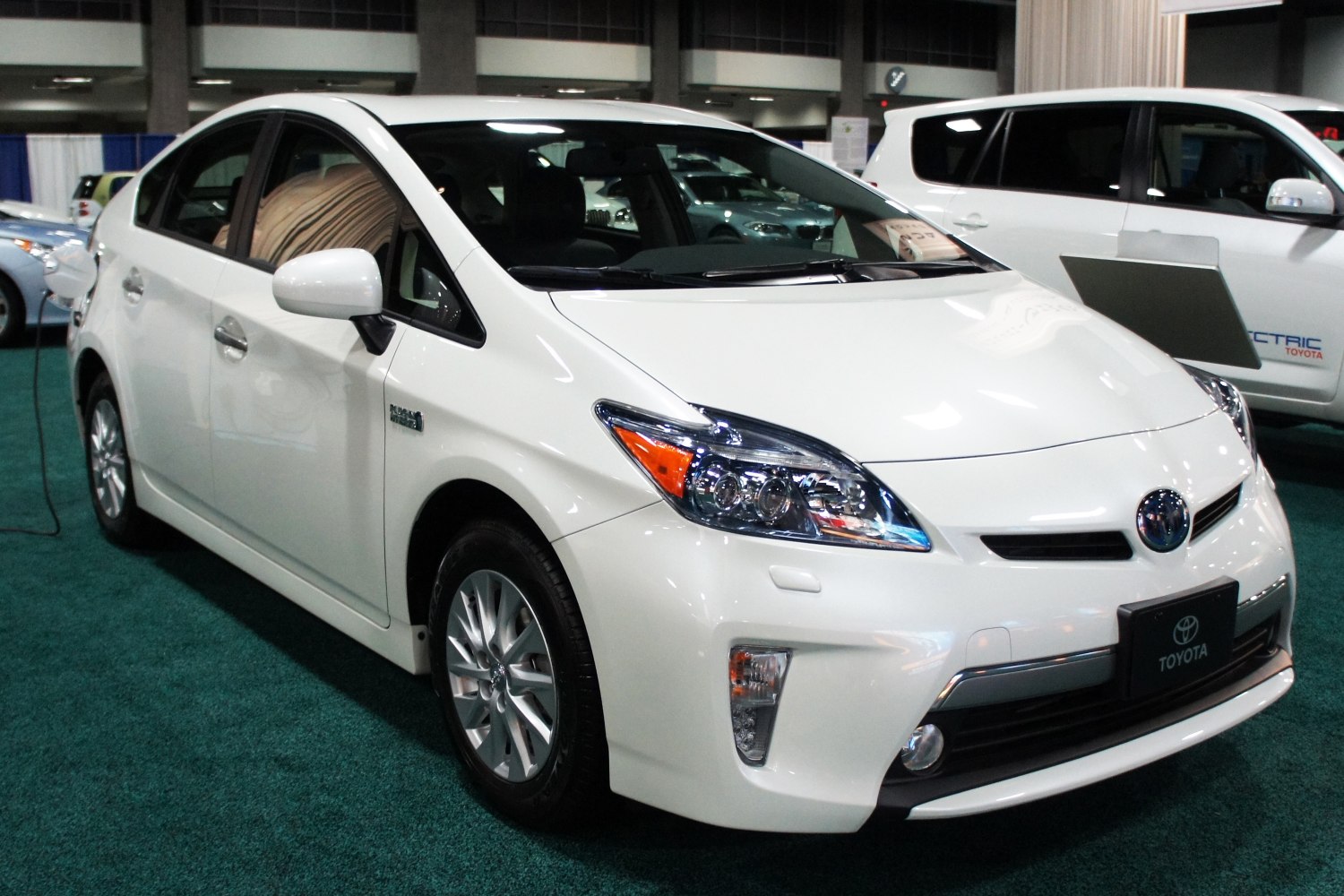 Front angled view of hybrid sedan with LED headlights and alloy wheels