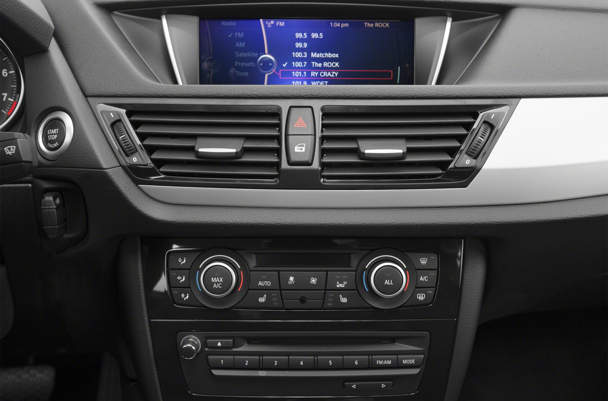 Dashboard with climate controls, radio interface, and start/stop button