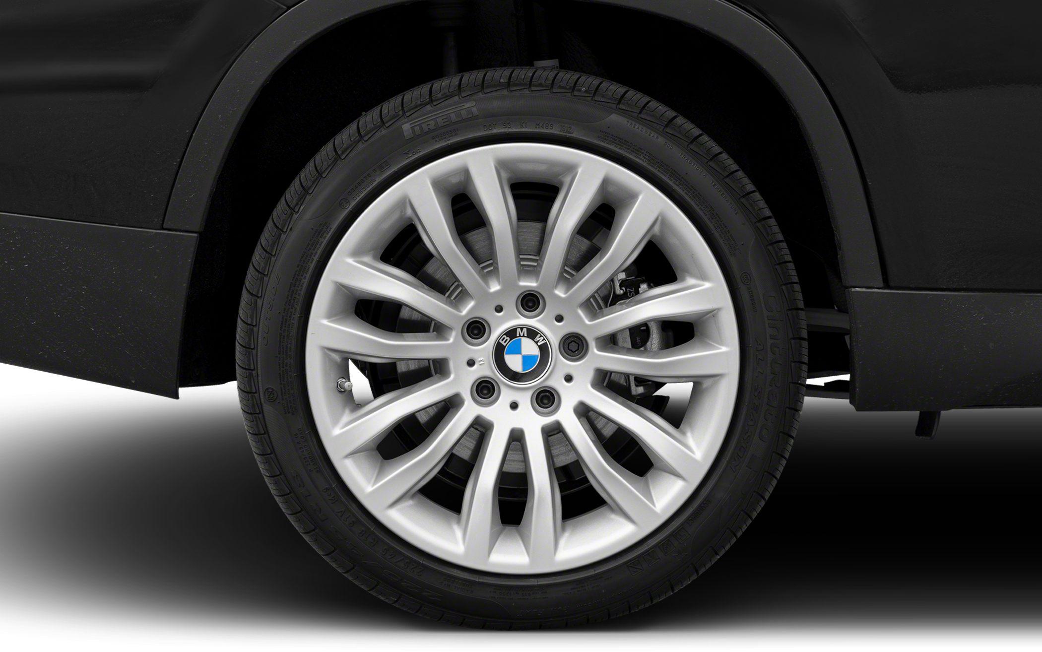 Multi-spoke silver alloy wheel and tire close-up.