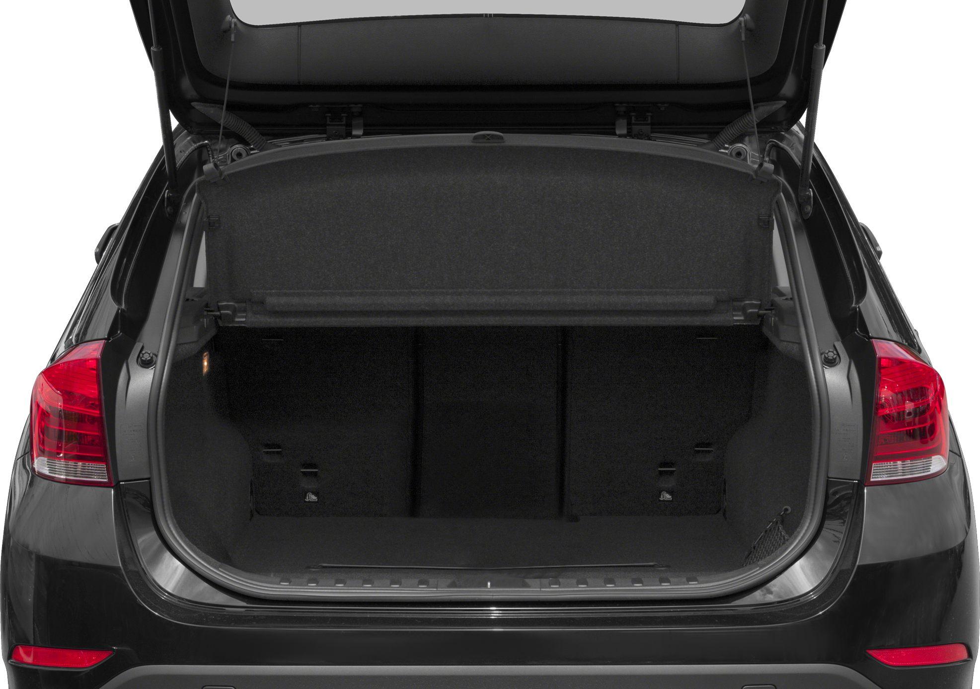 Open rear trunk space with cargo area and protective cover.