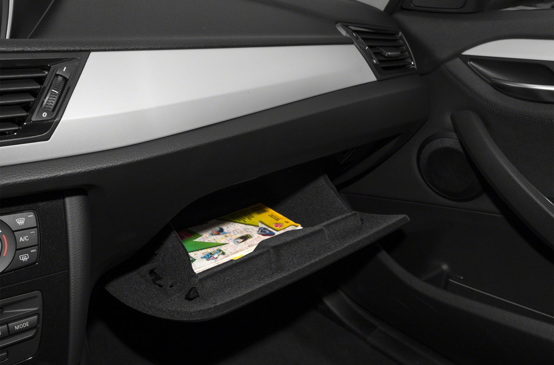 Open glove compartment and dashboard vents in modern car interior