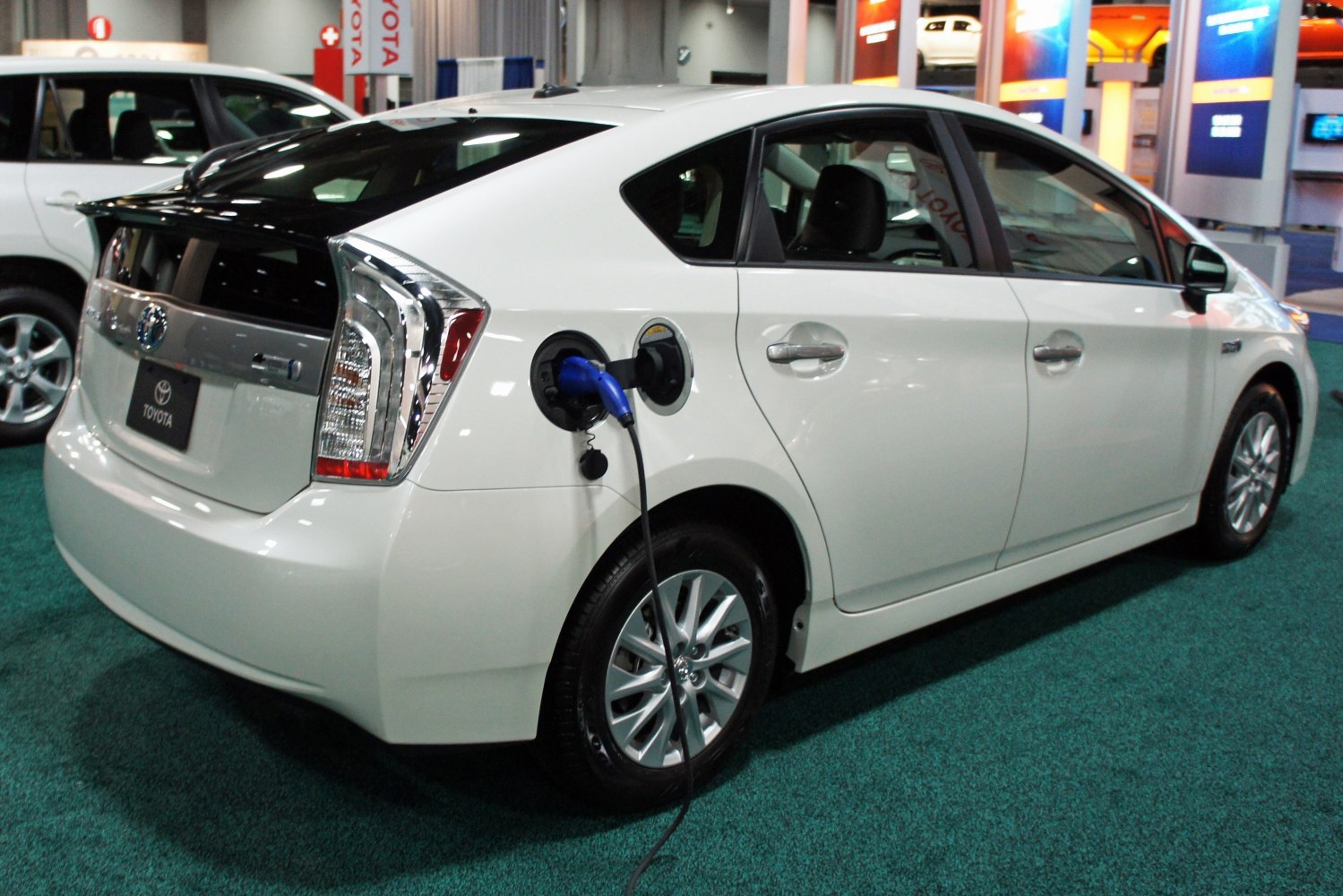 Side view of hybrid car with plug-in charging port connected