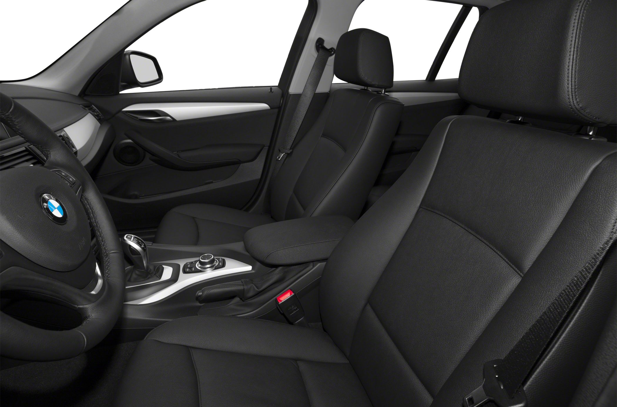 Front seats and dashboard with center console and gear lever.
