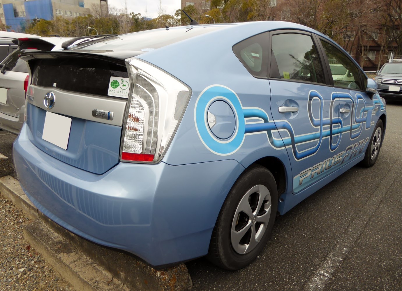 Rear-side view of hybrid hatchback with eco drive badge and hybrid synergy drive emblem