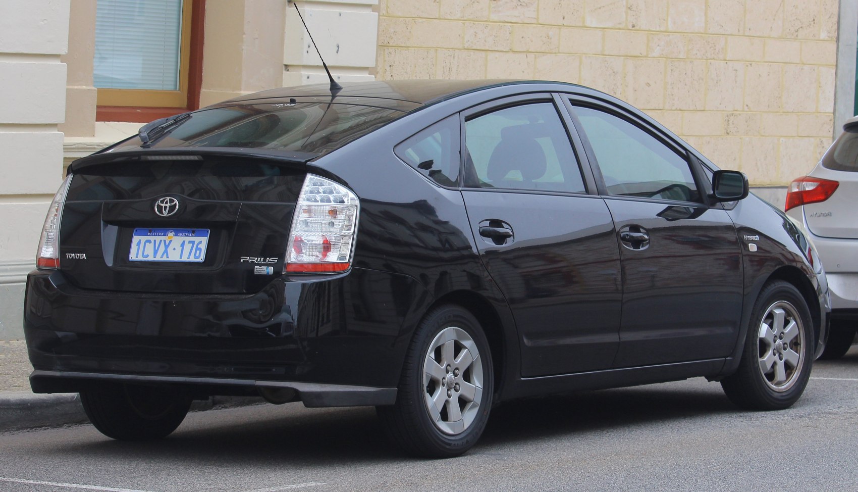 Rear and side view of a hybrid hatchback with aerodynamic design and hybrid badge.