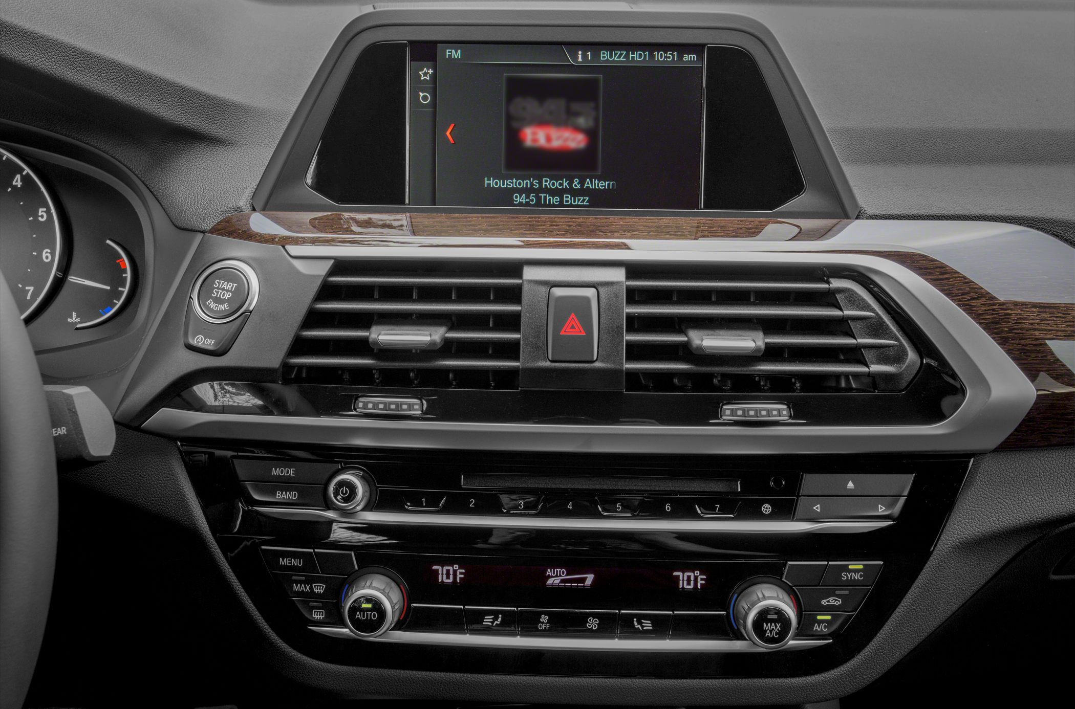Dashboard with infotainment screen, climate control, and engine start/stop button