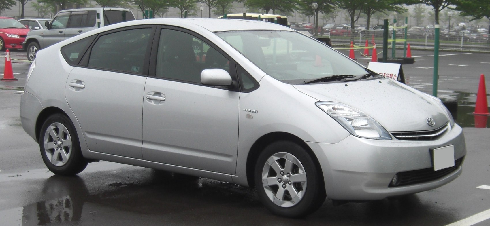 Silver five-door hybrid hatchback side profile with aerodynamic design and hybrid badge